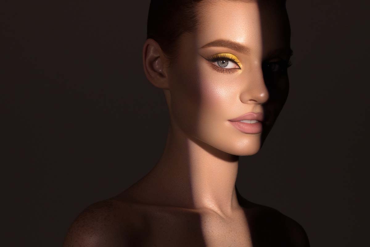 Woman in shadow with light cast on one eye after blepharoplasty in Plano, TX