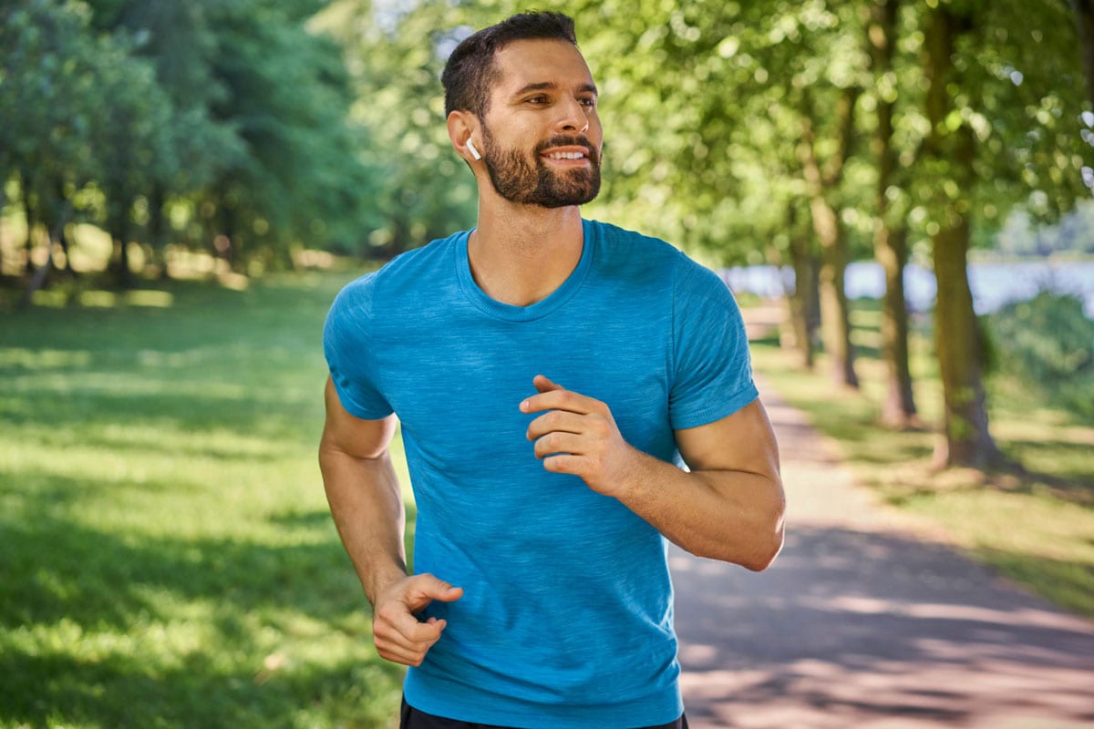 Man running with smile on his face after male plastic surgery in Plano.